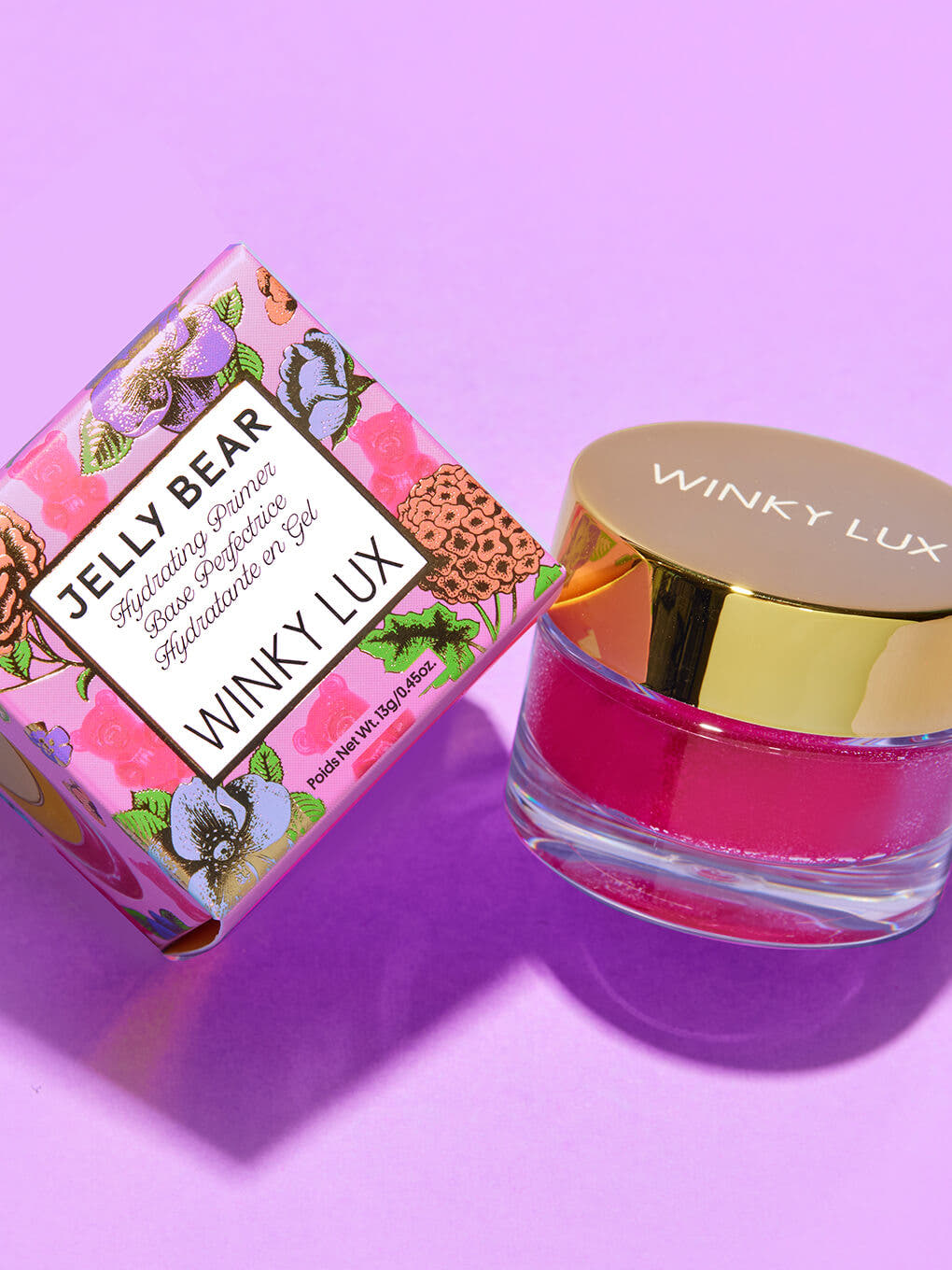 jelly bear hydrating face primer leaning against box on purple background