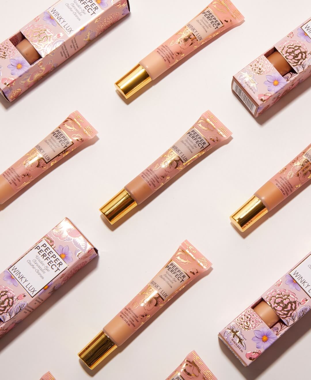 peeper perfect under eye concealers flat lay lined up in formation