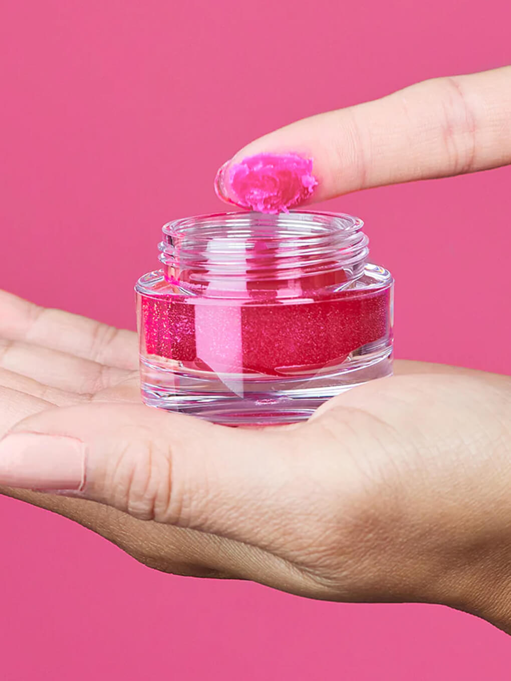 close up of finger dipping into pink jelly bear hydrating primer
